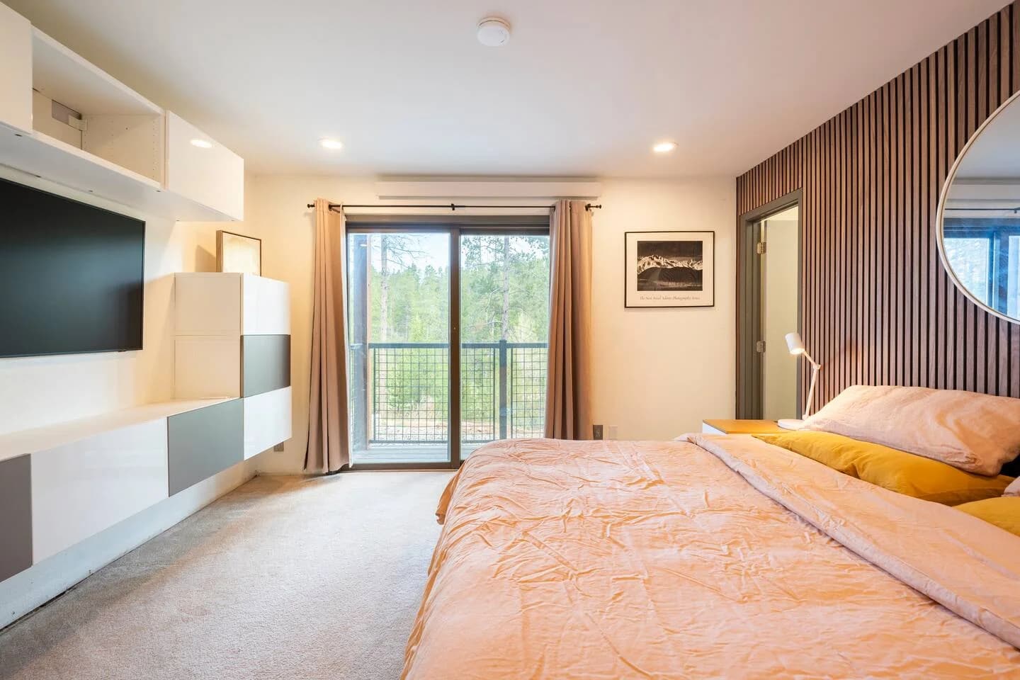 The master bedroom at The Jabberwocky, with a king bed and warm wood paneling